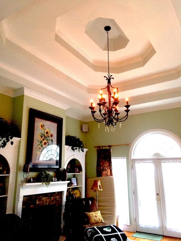 Finished coffered ceiling with smooth drywall and a chandelier