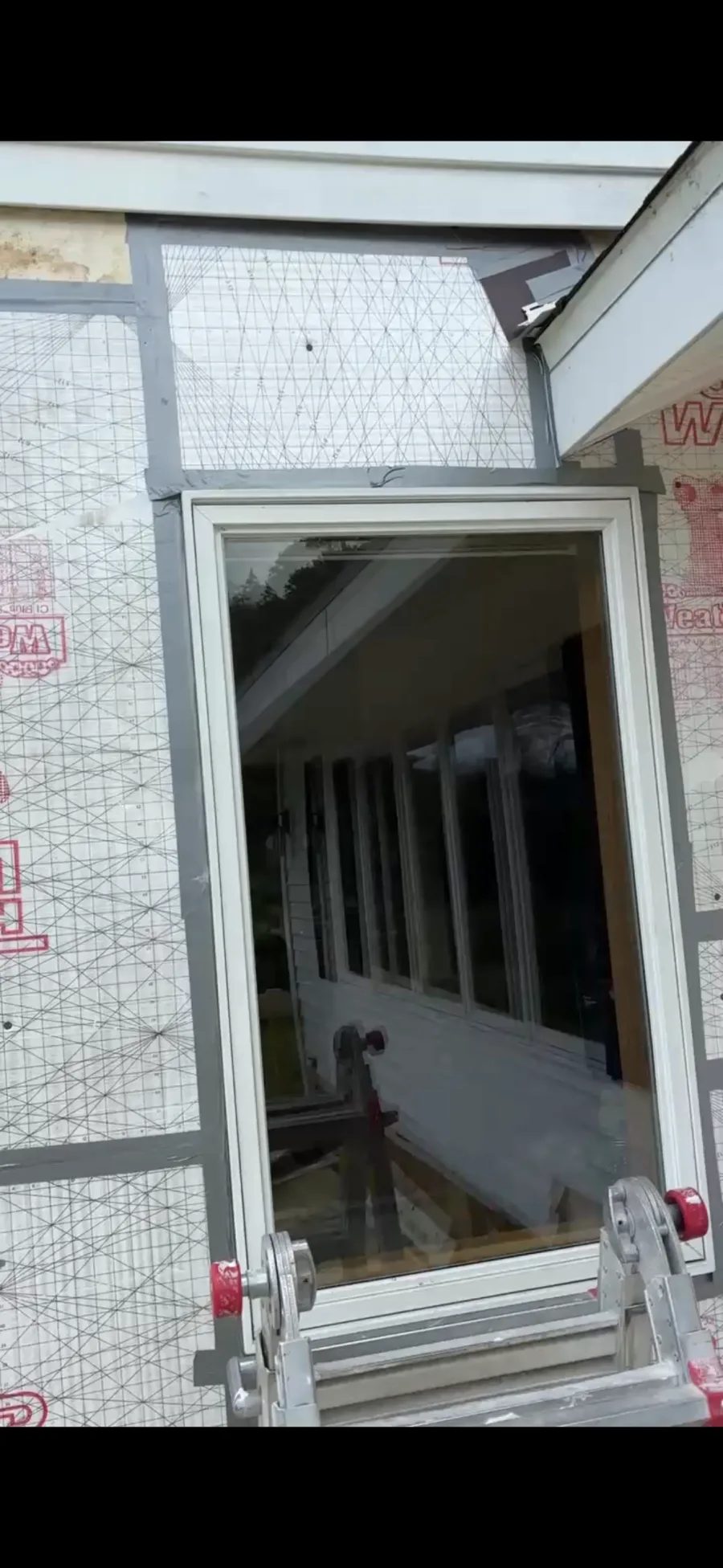 New Tyvek housewrap and flashing installed around a window after water damage repair